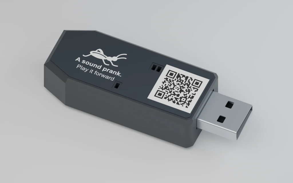 Cricket USB-A sound prank device with a charcoal enclosure, cricket label, LED windows and an instructions QR code